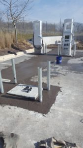 Black concrete with bollards at an electrical station