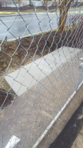 Fresh concrete sidewalk with control joints joining existing walkway