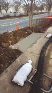 New concrete sidewalk panel poured flush with existing walkway