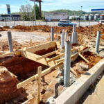 Excavation, forming, and conduit work under way for a commercial concrete