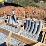 Forms, gravel base, and conduit are in place before the pour.